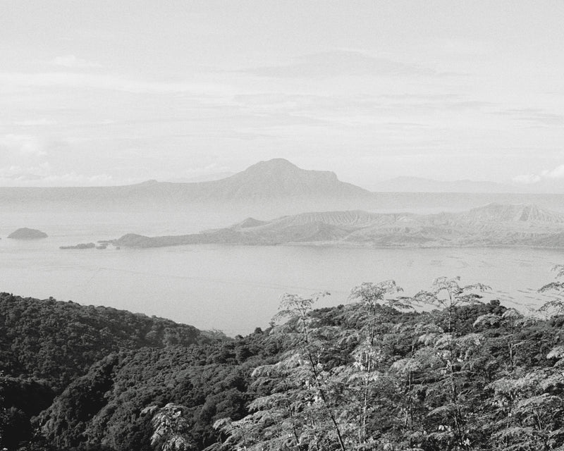 Black and white landscape of a mountainous area with misty background