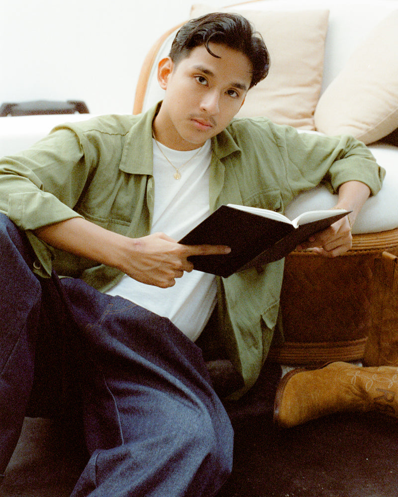 Person sitting on a couch reading a book