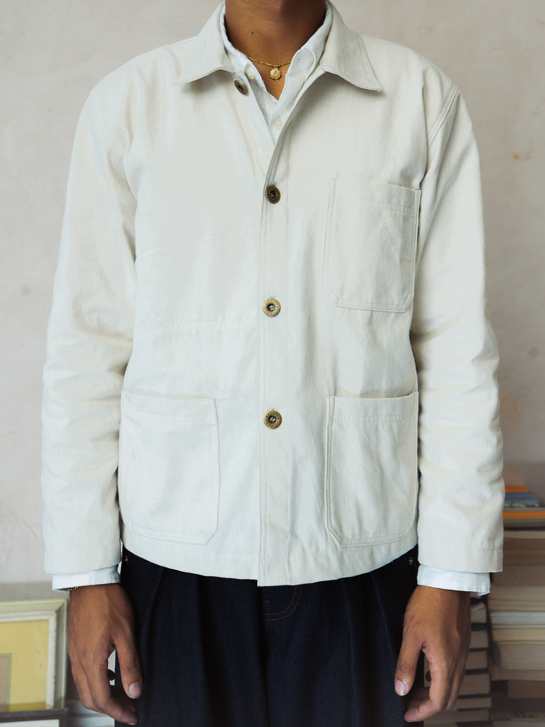 Cream canvas French Chore Jacket worn by a person against a neutral background