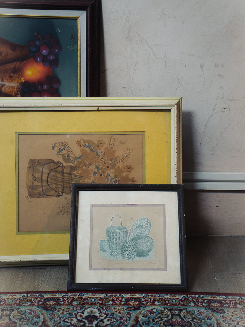 Three framed artworks on a textured surface with a neutral background