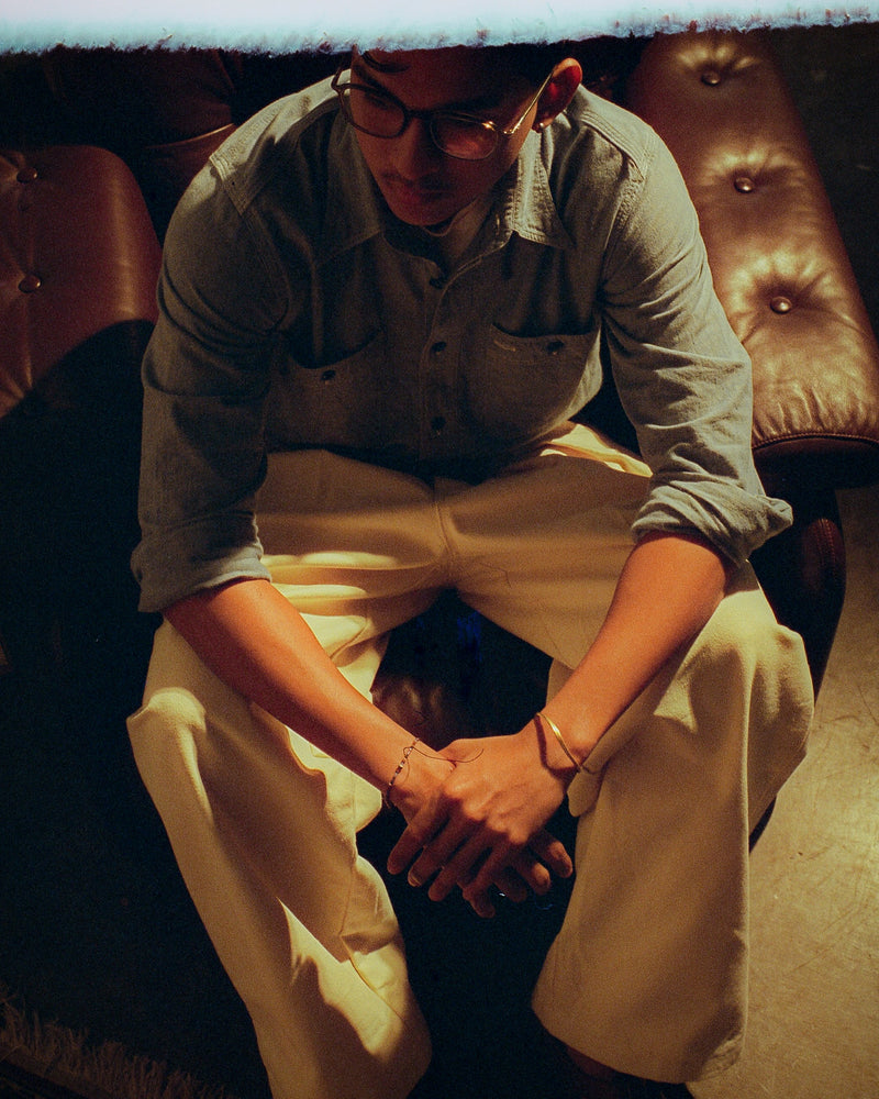 Person sitting on a leather couch with a warm, dimly lit ambiance